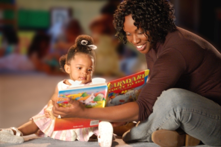 mom reading with infant